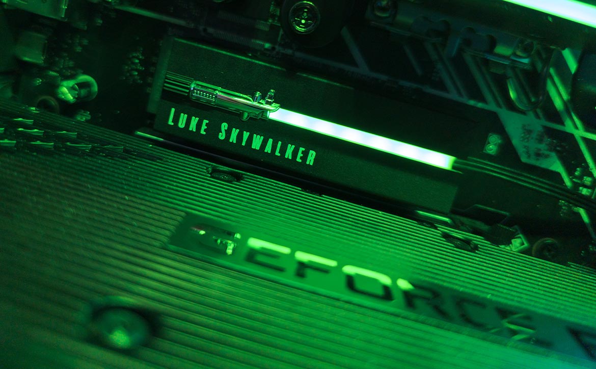 The Seagate Lightsaber Legends Special Edition FireCuda PCIe Gen4 NVMe SSD installed in a computer with green RGB LEDs lit